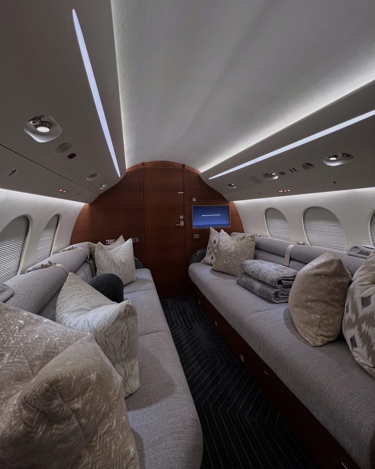 Detailed private jet cabin with divan and throw pillows